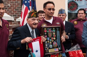 Rocco Moretto displaying the "The Big Red One" – 1st Infantry Division Insignia and his collection of awarded medals and ribbons, all presented by VFW Post 2348. Rocco is standing with VFW Post 2348 member Andy Cheng.